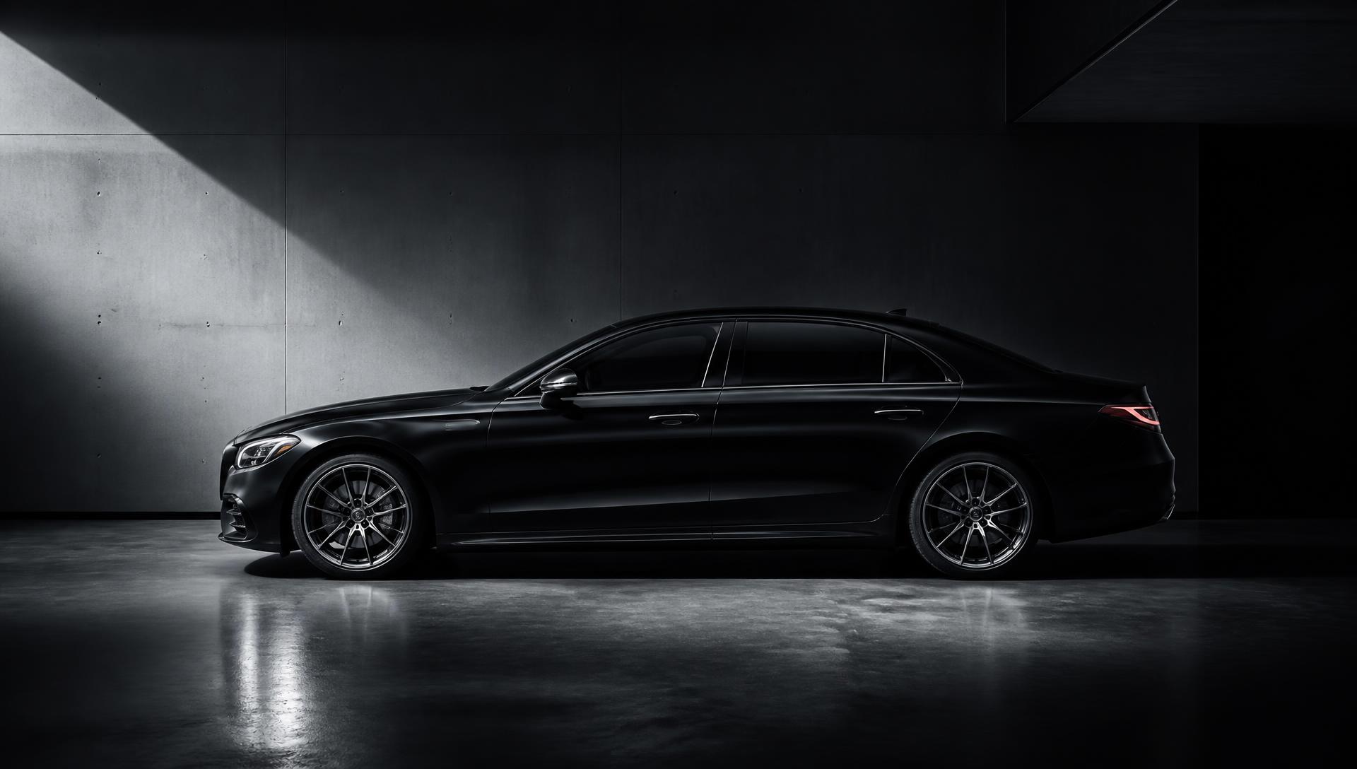 Luxury sedan with dark ceramic window tint in dramatic studio lighting